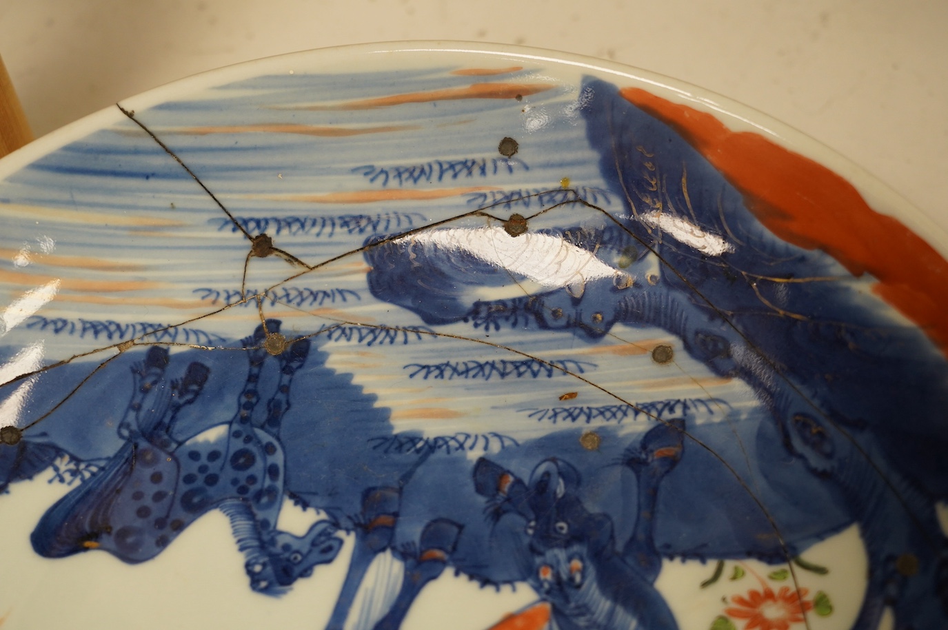 A Chinese underglaze blue and red and green enamelled 'horses' dish, Yongzheng period, 28.5cm. Condition - poor